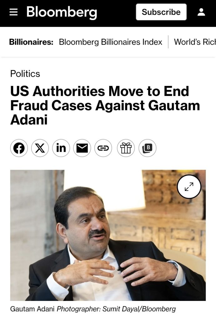 adani_bloomberg | No. 1 Indian Media News Portal Gautam Adani, in a dark suit and white shirt, sits in a studio interview setting, gesturing with his hands while speaking.