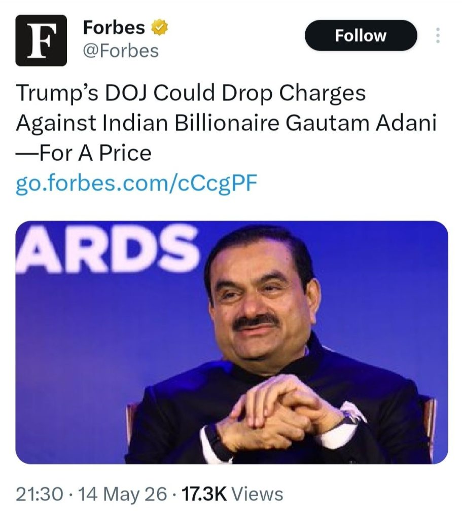 adani_forbes | No. 1 Indian Media News Portal Forbes post about DOJ charges against an Indian billionaire; photo of a man in a dark suit seated with hands folded on a blue stage.