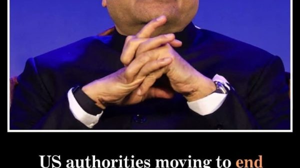 Close-up of a man in a dark suit, hands clasped, with a meme caption about US authorities ending fraud cases against a business figure (no name shown).