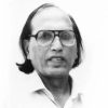 Black-and-white head-and-shoulders portrait of a man with glasses and medium-length hair, looking at the camera.