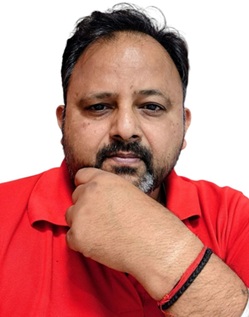 Portrait of a man with short hair and a beard wearing a red polo shirt, resting his chin on his hand against a white background.