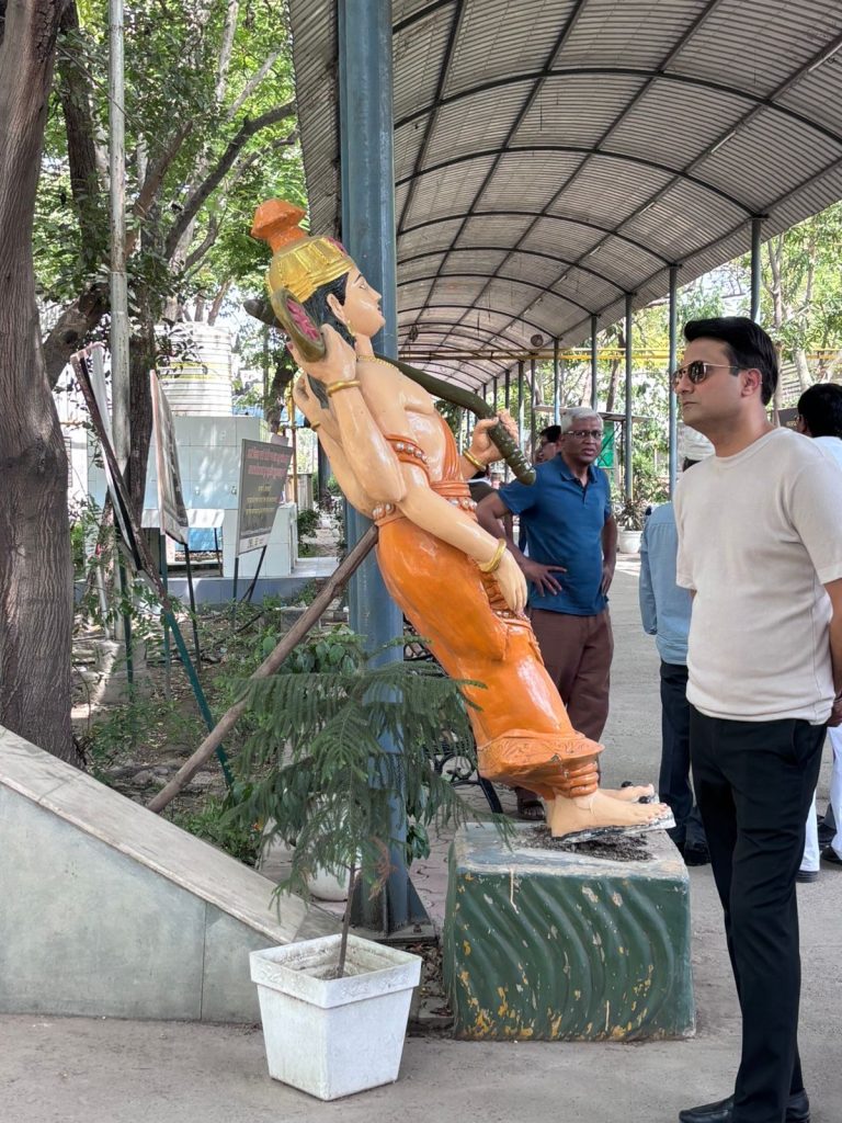 cea8c2ee-9e37-4133-a992-db18ff79a479 | No. 1 Indian Media News Portal Statue of a Hindu goddess in orange attire leaning backward under a covered walkway, with onlookers nearby.