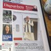 Tablet displaying the Norwegian newspaper Dagsavisen front page, featuring Narendra Modi's image and several side stories on the left.