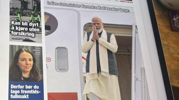 Tablet displaying the Norwegian newspaper Dagsavisen front page, featuring Narendra Modi's image and several side stories on the left.