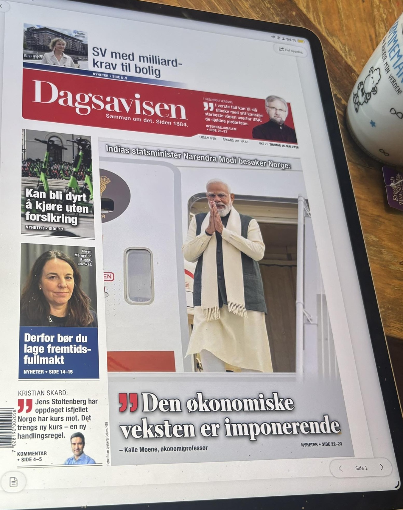 Tablet displaying the Norwegian newspaper Dagsavisen front page, featuring Narendra Modi's image and several side stories on the left.