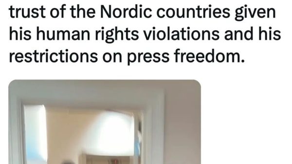 Tweet by Helle Lyng about PM Modi and an elevator, with a photo of people in business attire walking through a hallway toward an elevator.