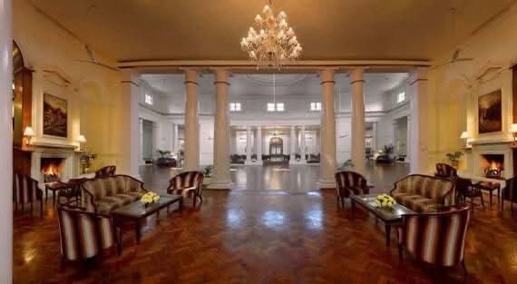 img_8589 | No. 1 Indian Media News Portal Grand hotel lobby with a chandelier, cream columns, and symmetrical seating areas on polished wooden floors.