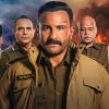 Dramatic movie poster with a stern police officer in front, flanked by three teammates, and flames in the background.