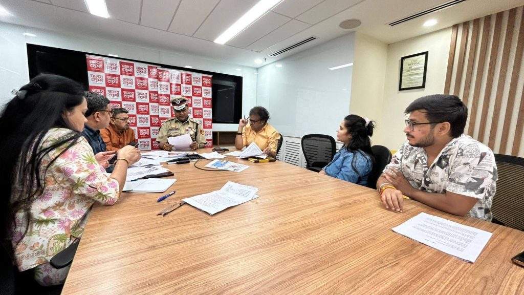 sandhya times | No. 1 Indian Media News Portal Group of six around a wooden conference table; a uniformed police officer reads a document while others review papers.