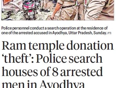 Police officers conduct a search operation in a narrow street, with bystanders and parked motorcycles nearby.