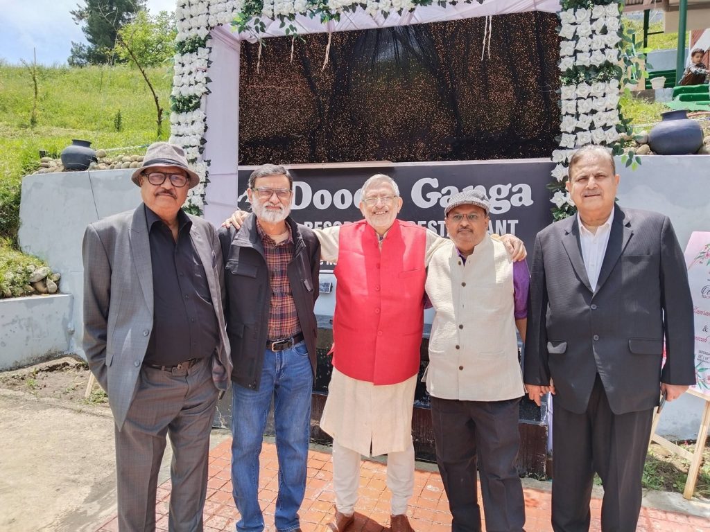 khabranvees_1 | No. 1 Indian Media News Portal Five men pose together outdoors in front of a flower-decorated stage with a banner; center man wears a bright red vest.
