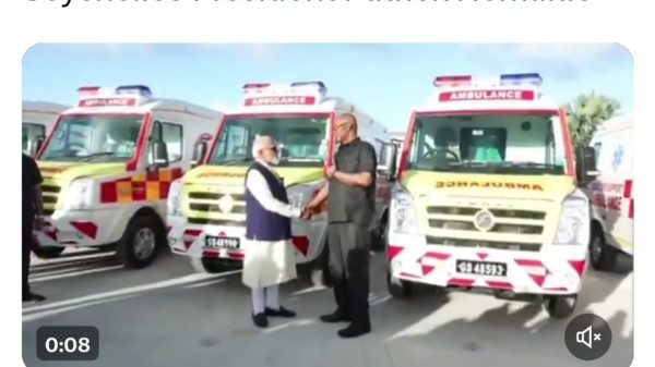Tweet image: two men shake hands beside three red-and-white ambulances, announcing PM Modi handing over ambulances to Seychelles president Patrick Herminie.