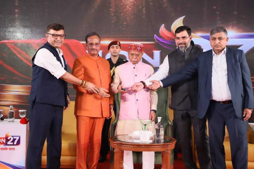 nation27_1 | No. 1 Indian Media News Portal Group of men in formal attire join hands in a ceremonial gesture on stage during a formal event, with a central elder man in pink attire.