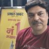 Selfie of a man with a maroon shirt standing in front of a yellow Prabhat Khabar newspaper poster advertising Jharkhand's number 1 newspaper.