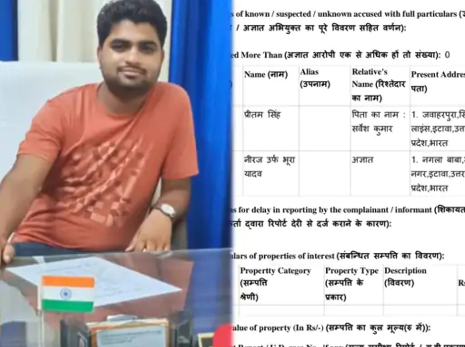Man in an orange t-shirt sits at a desk with an Indian flag on a document holder in front of a blue curtain backdrop.