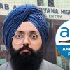 Portrait of a Sikh man with a blue turban and beard, wearing glasses, in front of the Punjab High Court entrance with an AAP logo overlay on the right.