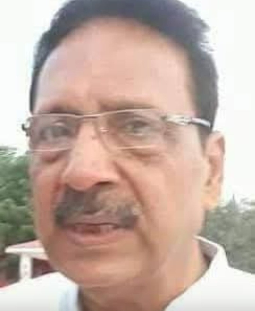 Close-up portrait of a middle-aged man with glasses and a mustache outdoors