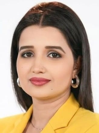 surabhi tiwari | No. 1 Indian Media News Portal Portrait of a woman with straight dark hair, gold hoop earrings, and a yellow blazer, looking at the camera with a slight smile.