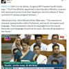 A woman in a blue sari speaking at a Parliament session, with other MPs seated behind.