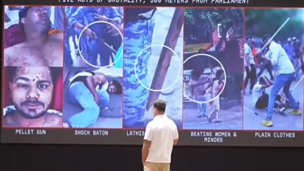 Man facing a large screen infographic titled 'Bharat ke Bachchon ko Maara Hai' showing five acts of brutality: pellet guns, shock batons, lathis, beating women and minors, and plain-clothes officers.