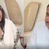 Two people seated in a private jet; a woman in a floral shawl speaks while a man with a microphone listens.