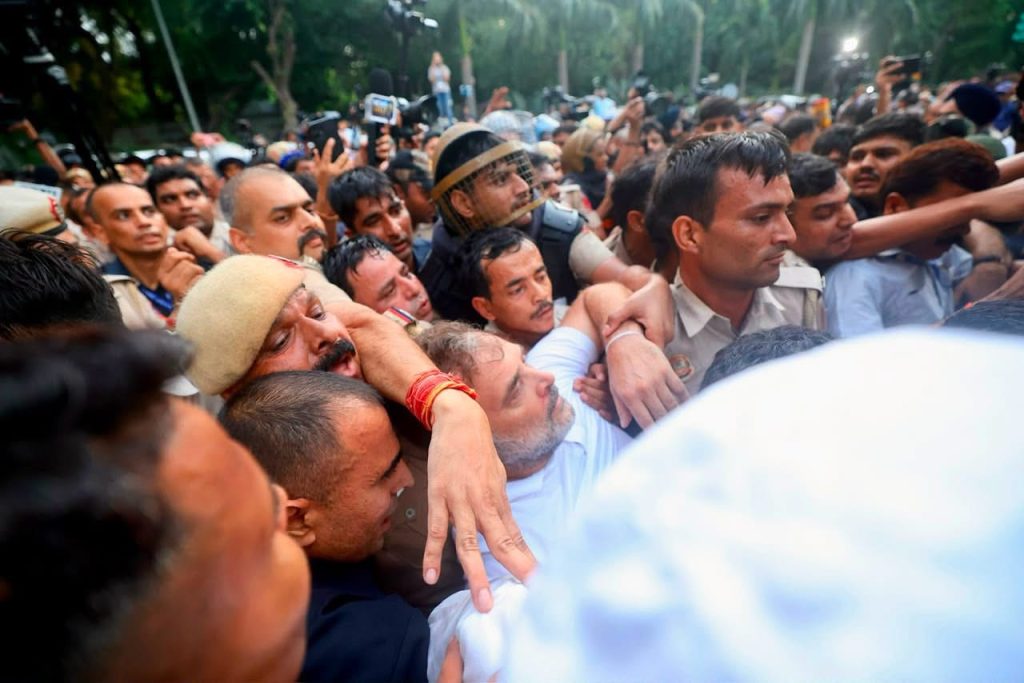 img_9871 | No. 1 Indian Media News Portal Dense crowd of men in a street protest, several arms interlocked as people push forward toward a goal.
