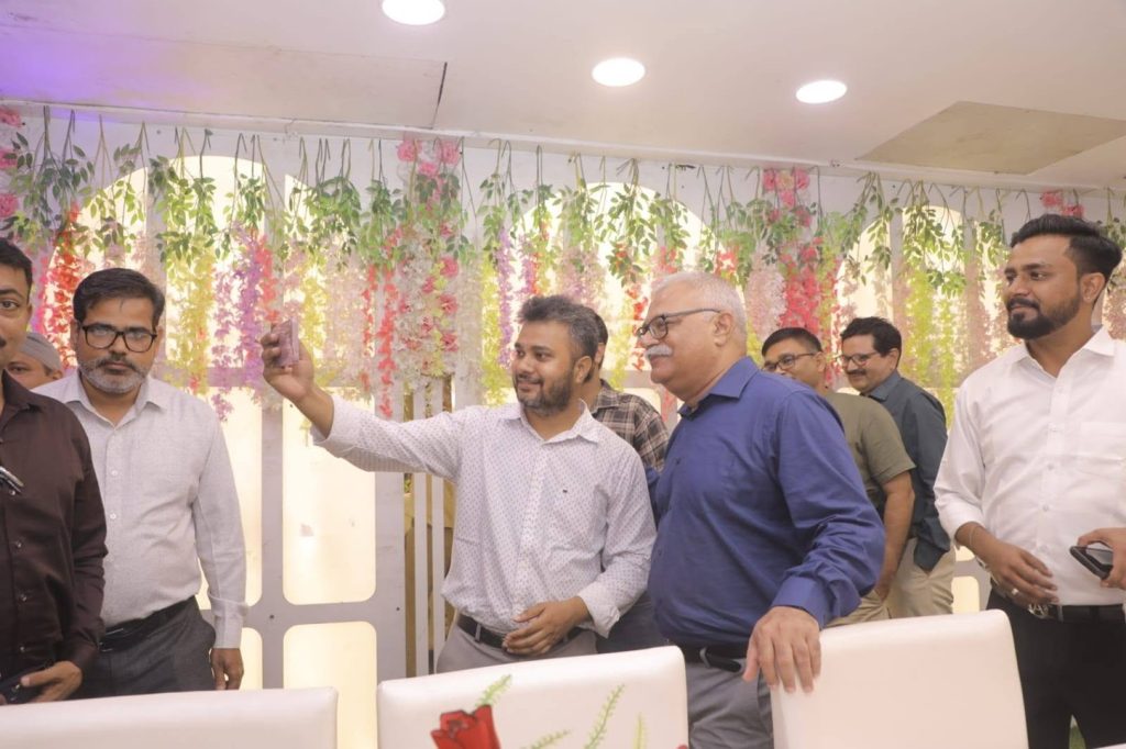 indu shekhar_2 | No. 1 Indian Media News Portal Group of men taking a selfie at a celebration with hanging floral decorations behind them.