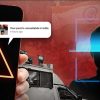 Phone screen shows a bright warning triangle; chat bubbles warn 'Your post is unavailable in India' while a shadowy person sits within a blue facial-recognition frame in the background.