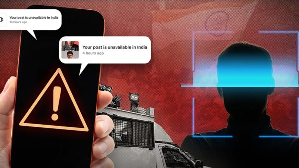 Phone screen shows a bright warning triangle; chat bubbles warn 'Your post is unavailable in India' while a shadowy person sits within a blue facial-recognition frame in the background.