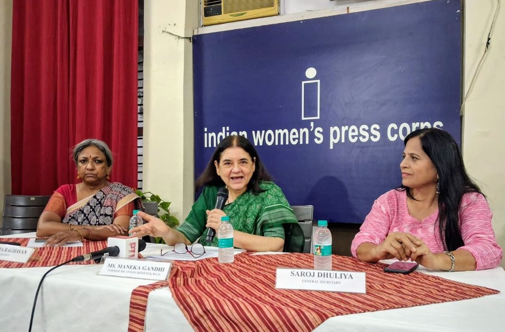 menka gandhi | No. 1 Indian Media News Portal Panel of three women seated at a press conference table with microphones, in front of a blue backdrop reading 'indian women's press corps'