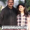 Man in a black outfit stands beside a young woman in a plaid scarf outdoors; bottom news banner reads about Dharmendra Pradhan's daughter, Instagram, and online backlash over US LLM studies.