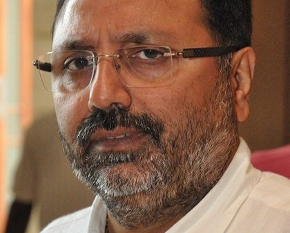 Close-up of a man with glasses and a graying beard looking at the camera.