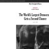 Grayscale close-up of a person’s back/head with a badge in focus, accompanying the NYT opinion piece titled 'The World's Largest Democracy Gets a Second Chance'.