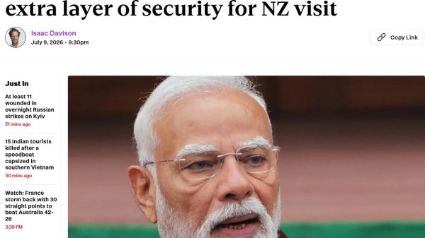 Close-up portrait of Narendra Modi, Indian prime minister, with white beard and glasses, accompanying a news article headline about his security during a NZ visit.