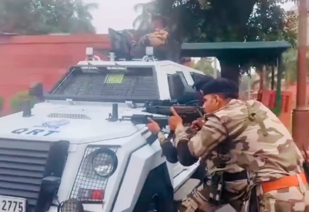 Screenshot | No. 1 Indian Media News Portal Soldier in camouflage aiming a rifle from the side of a white armored vehicle.