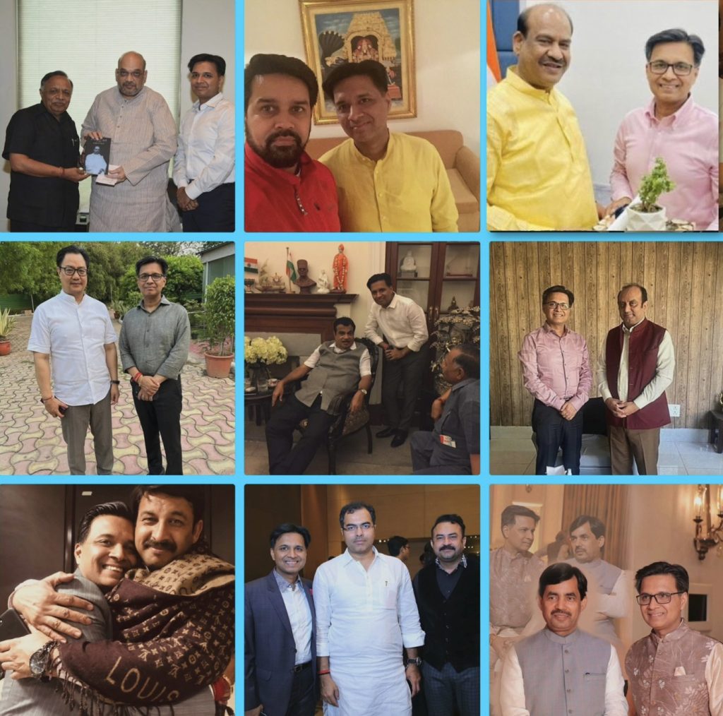 vikas garg_1 | No. 1 Indian Media News Portal Three men stand together indoors; one presents a photo to another.