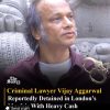 News post image: man in a maroon shirt with a carved stone background and a handcuffs graphic, about Vijay Aggarwal detention.