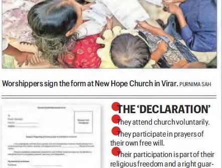 Worshippers gathered around a table, signing forms at New Hope Church in Virar.