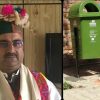 Portrait of a man in traditional attire with a flowered headdress on the left, beside green and blue recycling bins on the right.