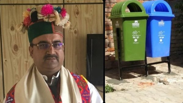 Portrait of a man in traditional attire with a flowered headdress on the left, beside green and blue recycling bins on the right.