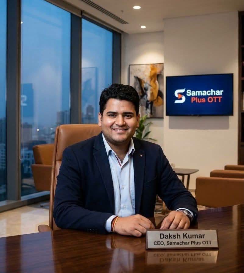 Daksh Kumar, CEO of Samachar Plus OTT, sits at a polished desk in a modern office, smiling at the camera.