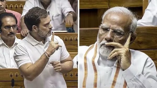 Two Indian politicians in white shirts: left figure gesturing with finger raised, right figure resting chin on his hand and looking pensive in a parliamentary setting