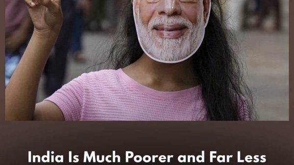 Person wearing a Narendra Modi mask and pink shirt, making a peace sign with fingers; image accompanies a headline about poverty in India.