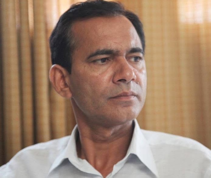 nadeem ansari | No. 1 Indian Media News Portal Portrait of a middle-aged man in a white shirt looking to the right, with wooden blinds in the background.