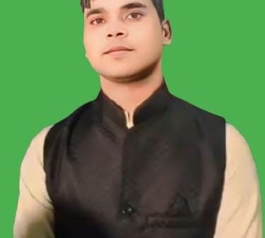 Portrait of a man wearing a black vest over a beige kurta against a solid green background.