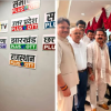 Men posing beside a wall of regional TV logos (Plus OTT): Punjab TV, UP, Jharkhand, Haryana, Rajasthan.