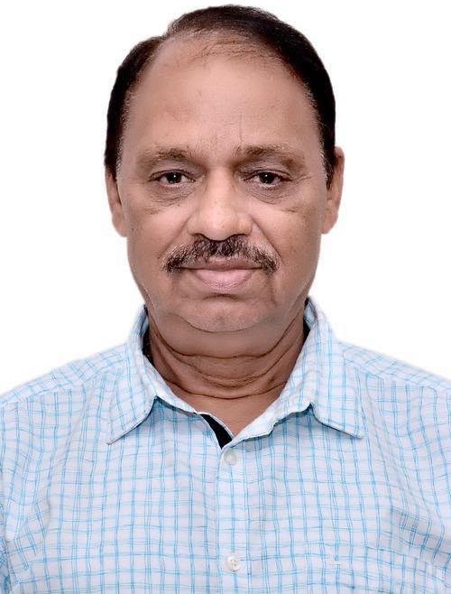rajesh singh | No. 1 Indian Media News Portal Portrait of a middle-aged man with short dark hair and a mustache, wearing a light blue checkered shirt against a white background.
