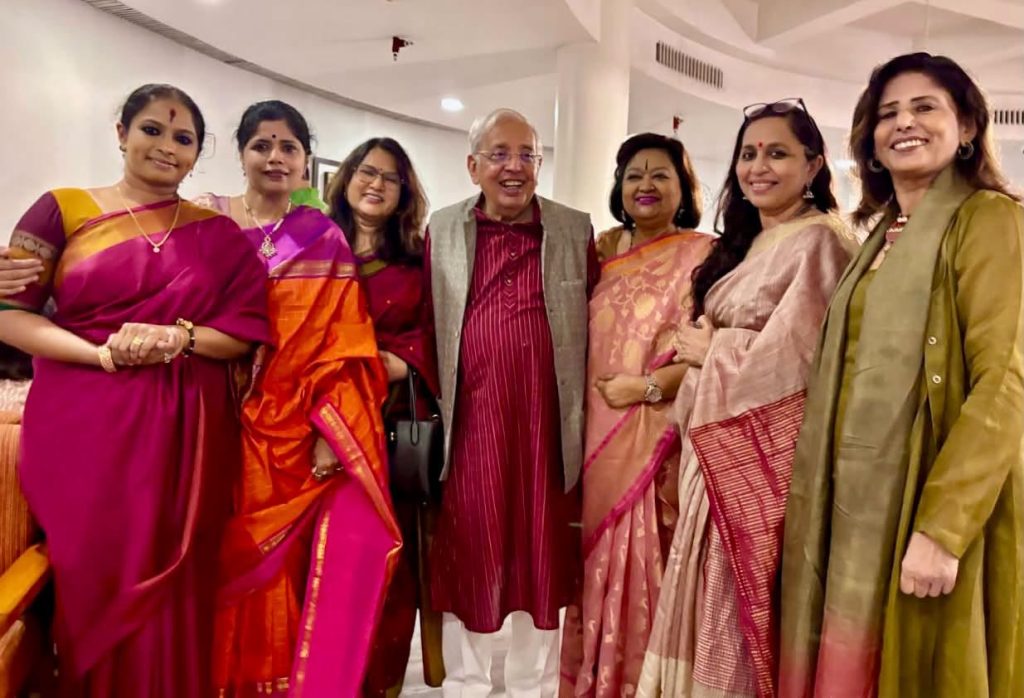 ashok_1 | No. 1 Indian Media News Portal Group of seven adults in colorful sarees and traditional attire posing together at an indoor event, smiling for a celebratory photo.
