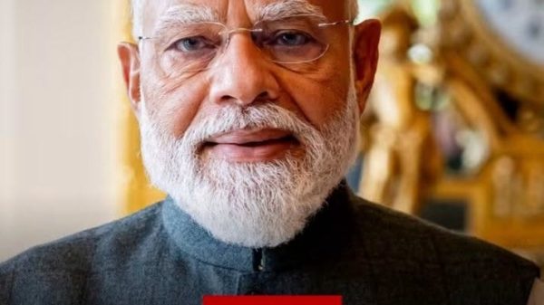 Close-up portrait of an elderly man with white beard and glasses, wearing a dark jacket, with a red Hindi caption and the BBC News Hindi watermark in the background. The overlaid Hindi text asks viewers for a birthday gift idea.