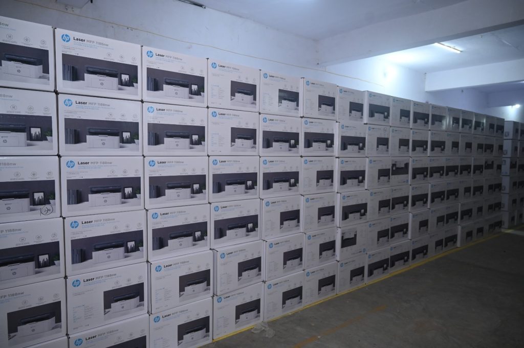 Rows of HP Laser MFP 1188nw printer boxes stacked in a warehouse.